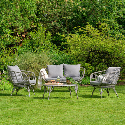 Outdoor patio set with chairs and table on a grassy area with trees in the background